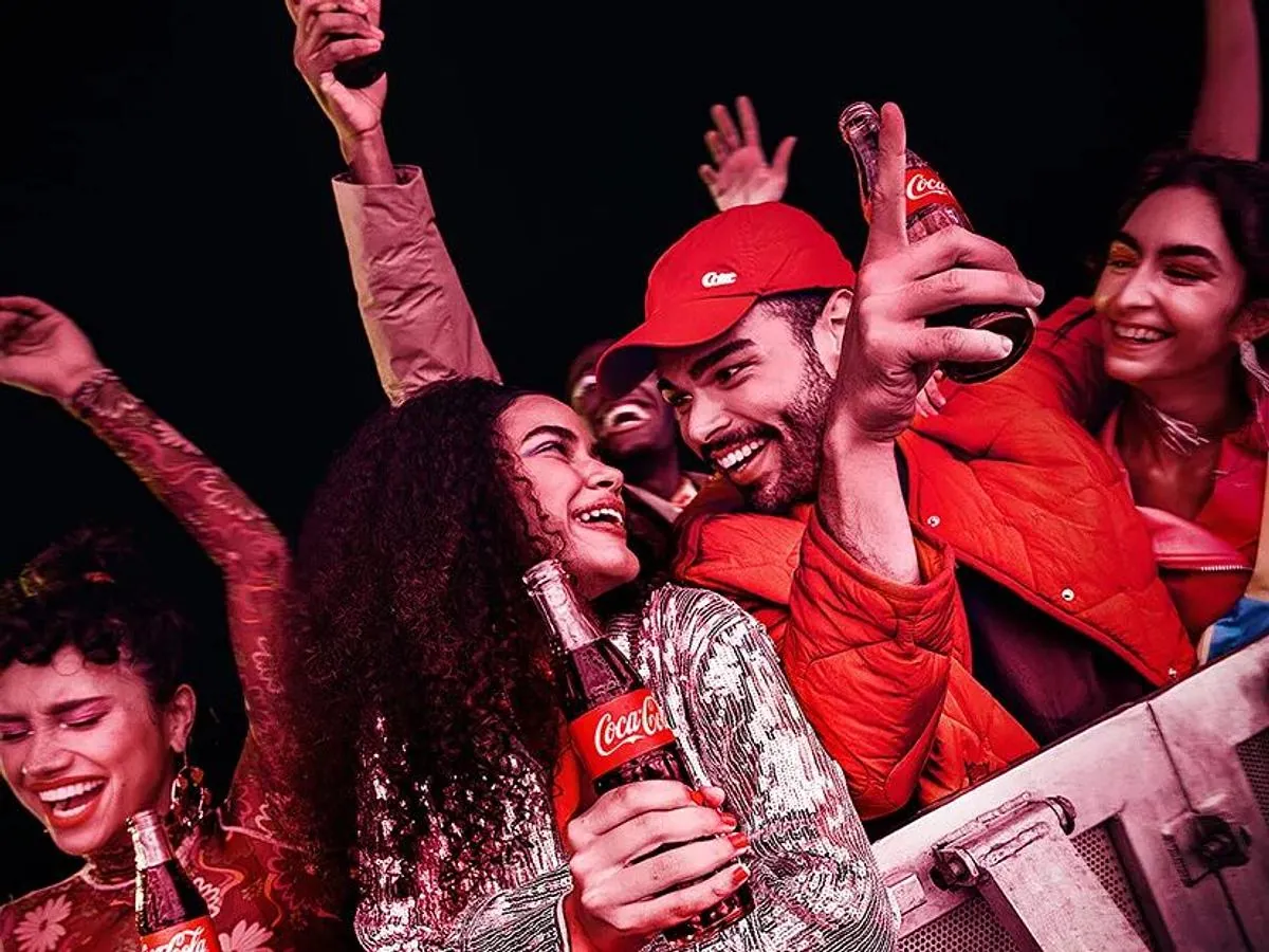Visitors celebrating with Coca-Cola drinks